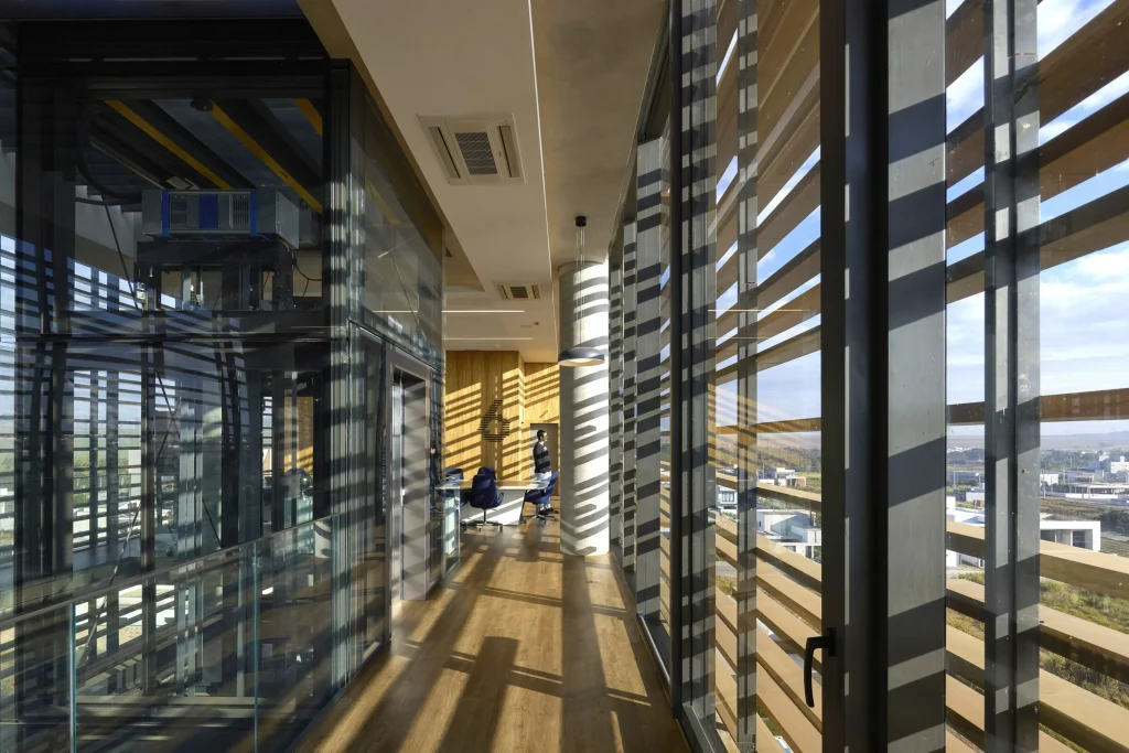 Open-plan interior workspace with long free spans and full-height glazing