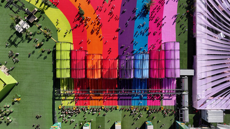 BIG Turns Madrid into Macondo Park for Shakira’s Residency_Aerial view of rainbow-coloured pathways and modular fabric structures with crowds walking between them
