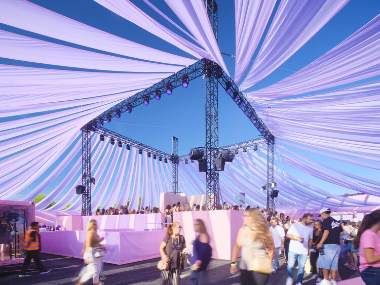 BIG Turns Madrid into Macondo Park for Shakira’s Residency_Interior of a pavilion with lavender fabric drapes suspended from a black truss structure
