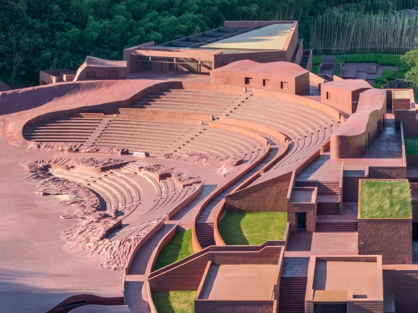 Aerial view of the reddish-brown amphitheater seating curving into the green hillside