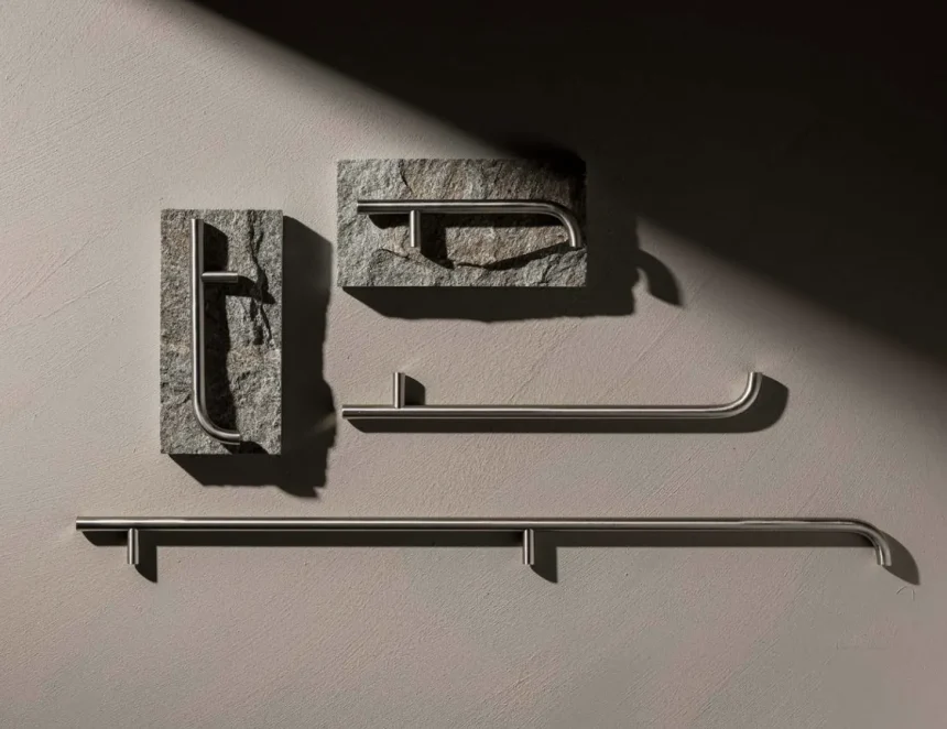 Close-up of custom cabinet handles combining brushed stainless steel and natural stone, highlighting geometric forms, material textures, and modern hardware design