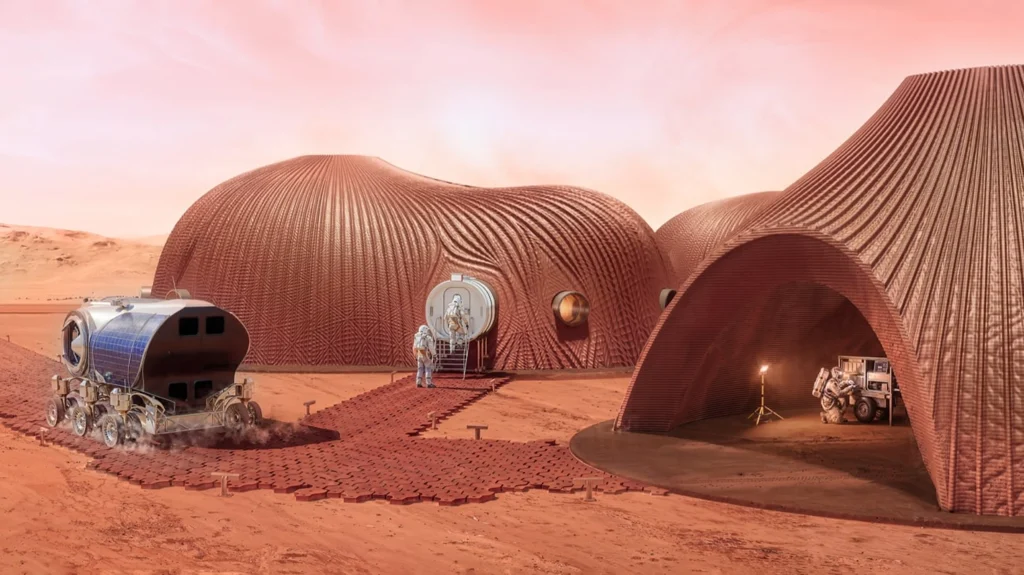 Rendering of curved reddish 3D-printed Mars habitats with astronauts, a solar-powered rover and equipment on the red planetary surface under a pink sky