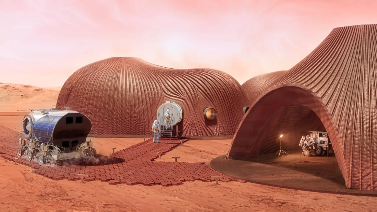 Rendering of curved reddish 3D-printed Mars habitats with astronauts, a solar-powered rover and equipment on the red planetary surface under a pink sky