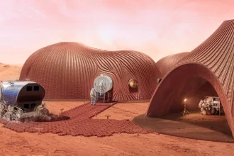 Rendering of curved reddish 3D-printed Mars habitats with astronauts, a solar-powered rover and equipment on the red planetary surface under a pink sky