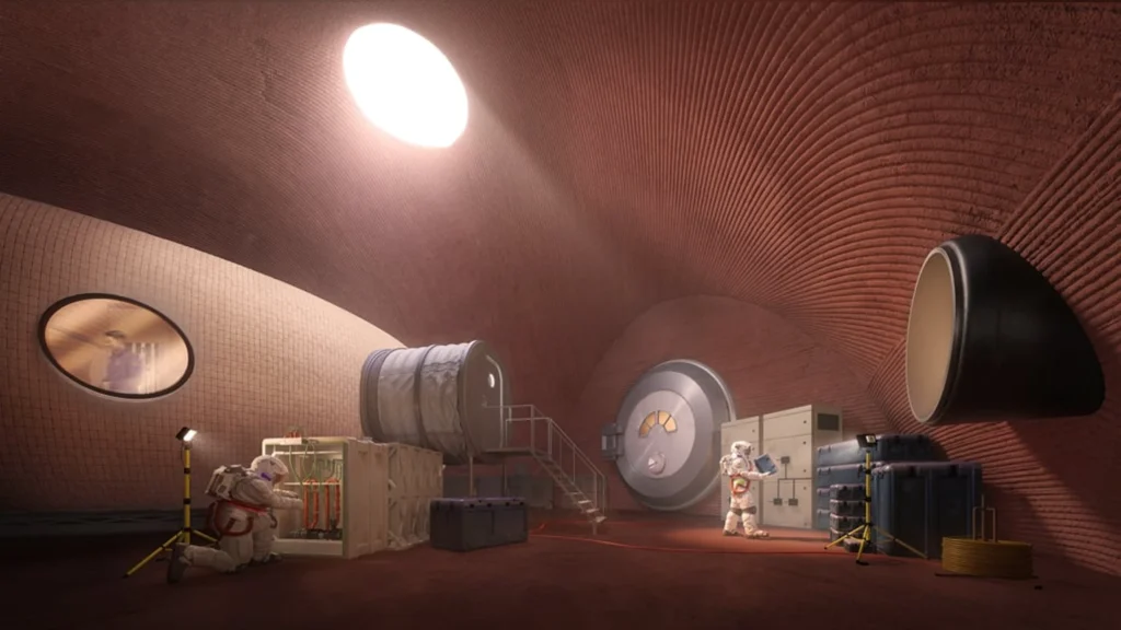 Interior of a curved reddish habitat with ribbed walls, circular windows, astronauts working among equipment and soft overhead lighting