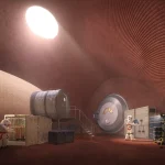 Interior of a curved reddish habitat with ribbed walls, circular windows, astronauts working among equipment and soft overhead lighting