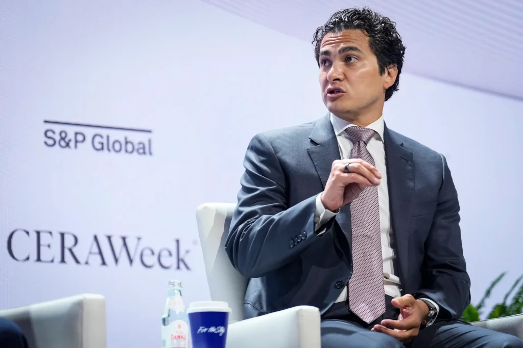 Chase Lochmiller speaking on stage at a CERAWeek panel moderated under the S&P Global banner