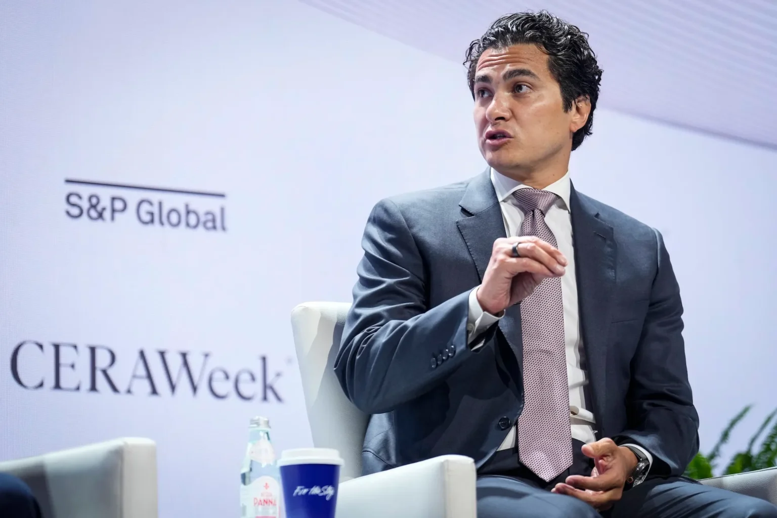 Chase Lochmiller speaking on stage at a CERAWeek panel moderated under the S&P Global banner
