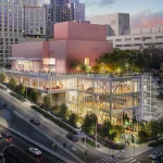 Evening rendering of the illuminated pink and glass building with people on the terrace and dancers visible inside