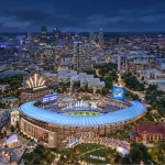 Night aerial rendering of the proposed Royals ballpark glowing blue amid the Kansas City skyline and surrounding district