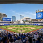 Interior view of the packed stadium looking toward the outfield fountains and crown-topped scoreboard under a clear sky