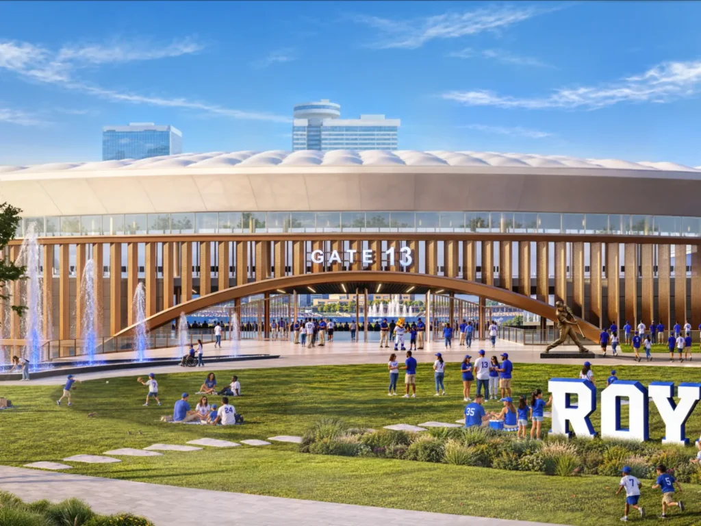 Daytime view of Gate 13 entrance with arched canopy, fountains, lawn and fans gathering outside