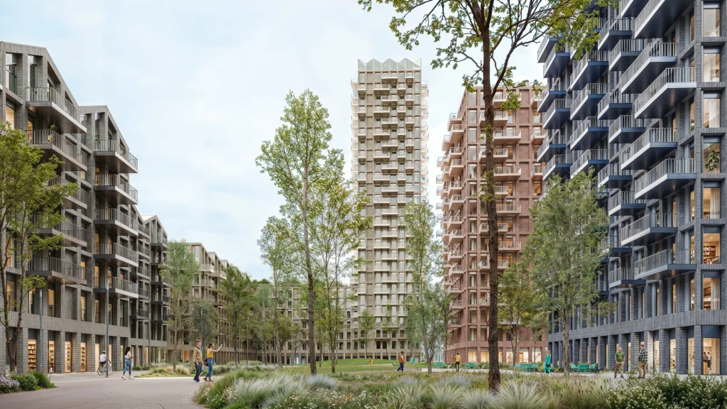 Wide view of the Loco Park neighbourhood with a tall tower and surrounding mid-rise blocks set among trees and landscaped paths under a bright sky