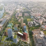 High aerial view of the complete Loco Park masterplan showing nine colourful residential buildings arranged around parks on the former industrial site