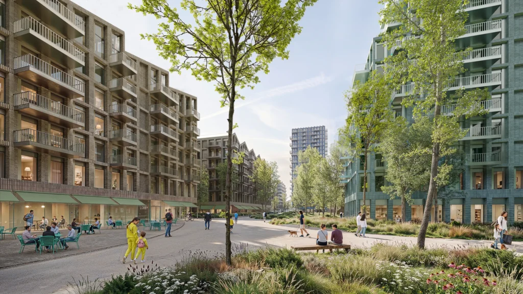 Tree-lined pedestrian street between mid-rise residential buildings with brick and green façades, outdoor cafés and people walking in a landscaped public space