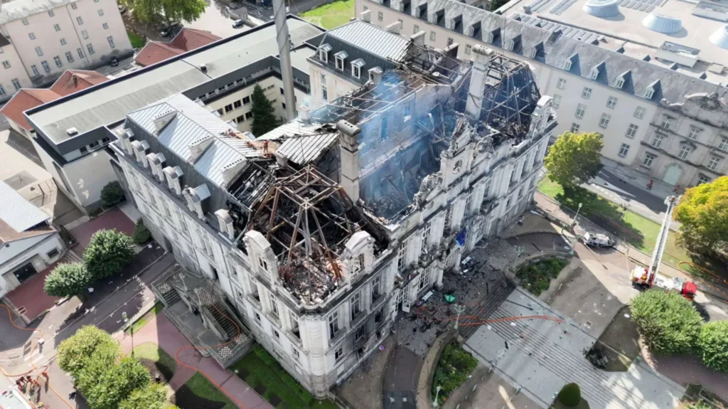 France Protests: 143-Year-Old Limoges Town Hall Goes Up in Flames_Aerial view of the Limoges town hall with its roof largely destroyed and smoke still rising from the charred structure