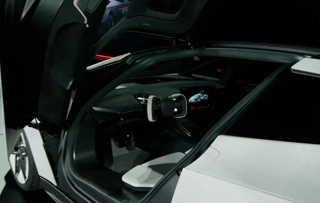 Interior view of the white Tesla Roadster showing the steering yoke and dashboard