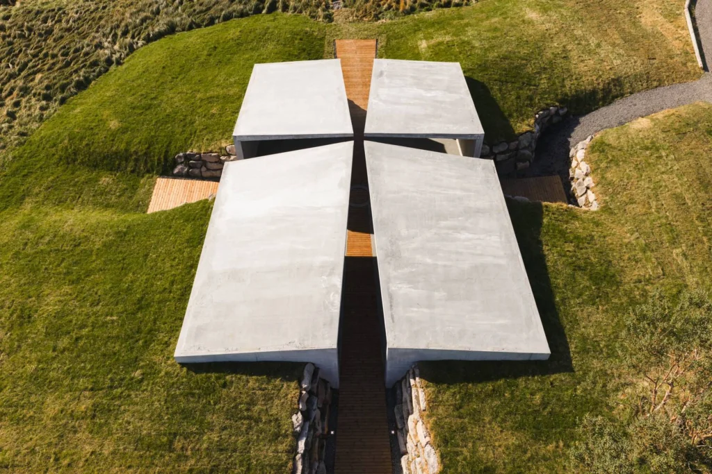 Direct overhead view of the four concrete roof arms forming a cross around the central wooden path and circle