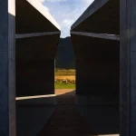 Looking out from inside the Temple through the concrete opening to sheep grazing in the field