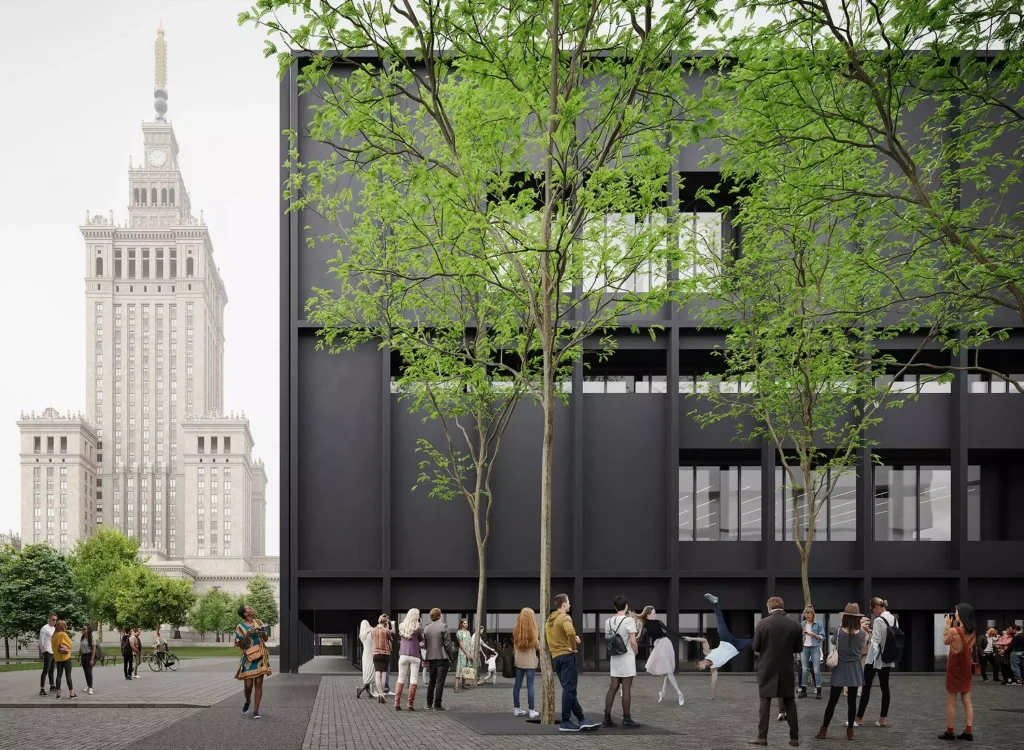 Dark rectangular building with regular window openings and green trees in the foreground, with the Palace of Culture and Science visible in the background and people gathered in the plaza