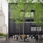 Dark rectangular building with regular window openings and green trees in the foreground, with the Palace of Culture and Science visible in the background and people gathered in the plaza