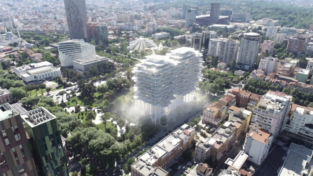 Aerial view of the white cloud-like Tirana Fountain Plaza raised on columns above Rinia Park amid the city skyline
