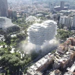 Aerial view of the white cloud-like Tirana Fountain Plaza raised on columns above Rinia Park amid the city skyline