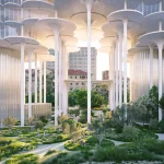 Ground-level view under the building showing tall white columns, hanging water curtains and landscaped public pathways