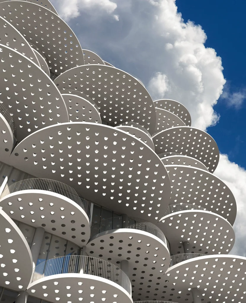 Close-up of stacked perforated white disks against a blue sky with scattered clouds