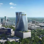 Wide aerial perspective of the O27 skyscraper near a highway with the Houston skyline in the background