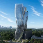 Aerial view of the sinuous glass O27 tower rising above a dark podium amid green surroundings and distant Houston skyline