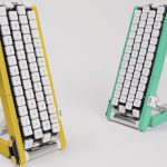Two Gboard conveyor-belt keyboards in yellow and mint green standing side by side