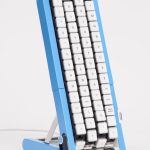 Blue Gboard conveyor-belt keyboard standing upright on a white background, showing white keycaps