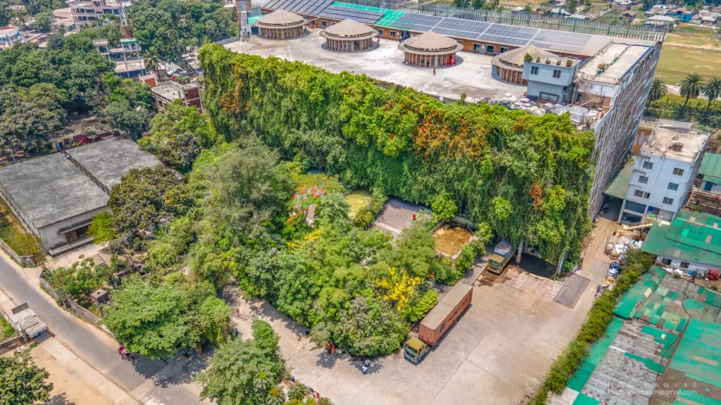 Aerial view of the entire Green Field Factory complex with rooftop solar panels and dense green wall