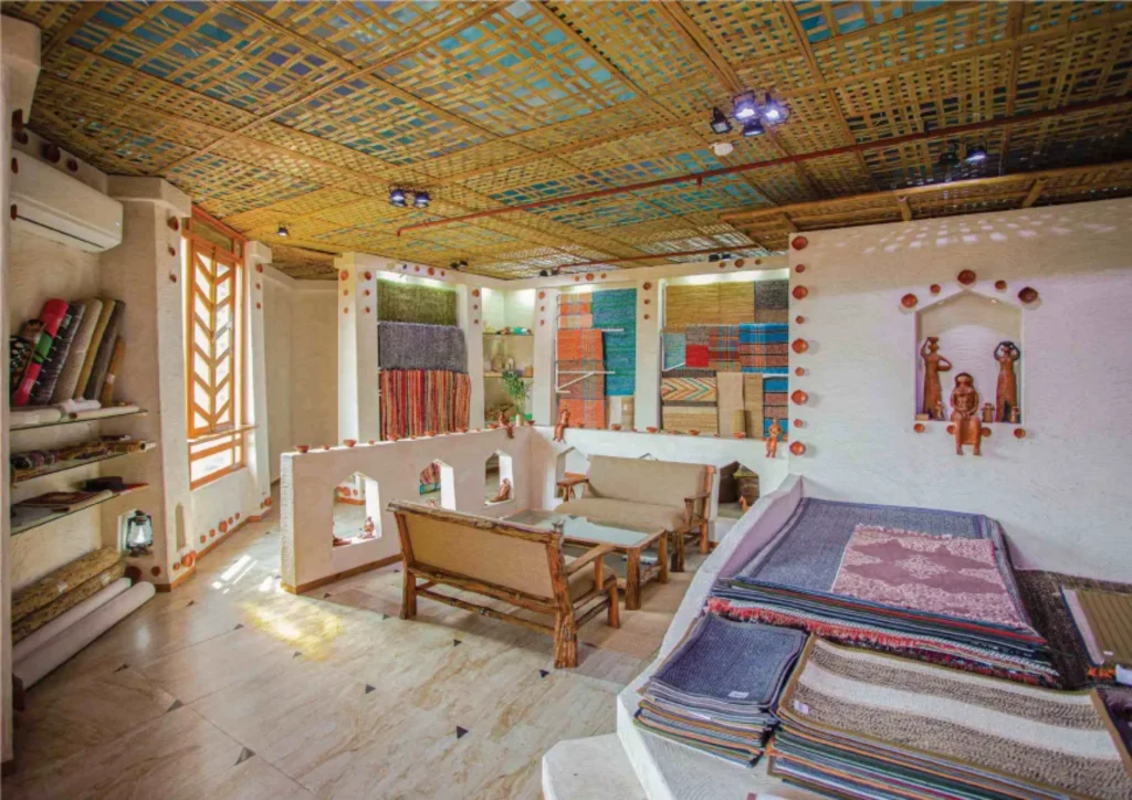 Interior showroom with woven ceiling, terracotta niches and displayed rugs