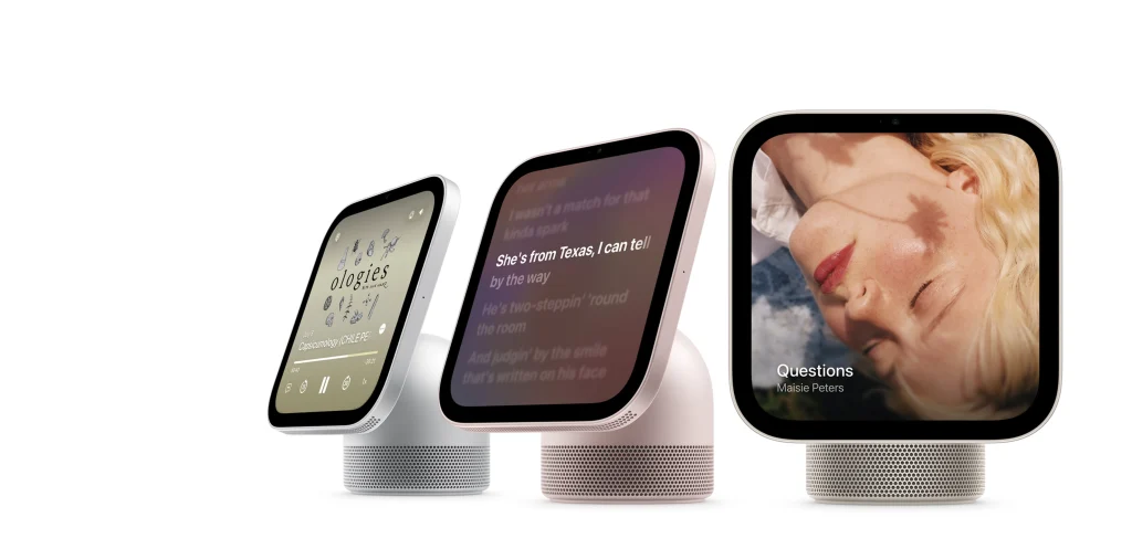 Three Apple HomeView units in different colours displaying podcast, lyrics and album art screens