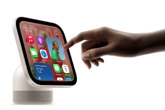 Hand interacting with a HomeView display showing apps, weather and calendar widgets