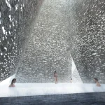 Rain falling heavily inside a high brick courtyard with people standing in shallow water, light filtering through openings in the walls