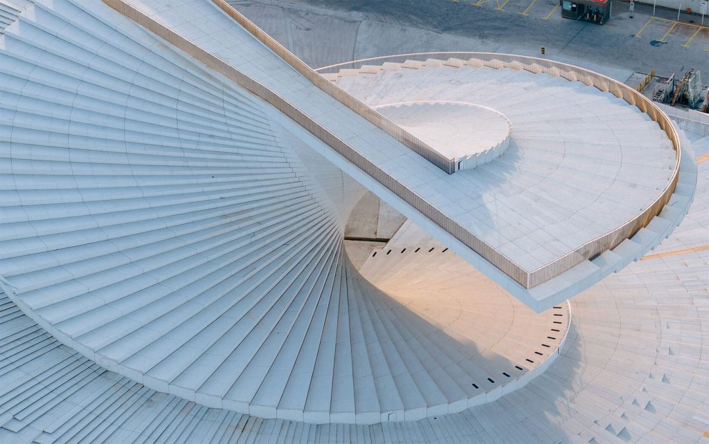 Aerial perspective of the interlocking white spiral forms of the roof terrace