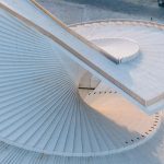 Aerial perspective of the interlocking white spiral forms of the roof terrace