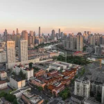 Aerial view of the TAFA Art Block core area within the denser Tianjin cityscape at dusk