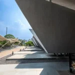 Close-up of sharp concrete edges and deep shadows cast by the overlapping planar forms of the pyres