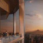 Elegant restaurant interior with floor-to-ceiling glass walls overlooking the city and Mount Ararat at sunset